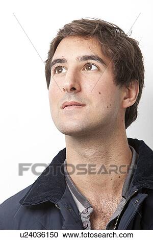 Handsome young Middle Eastern man looking away against white background View Large Photo Image Stock Image - Handsome young Middle Eastern man looking away against white background. Fotosearch