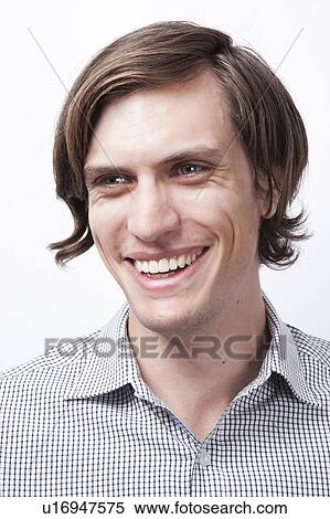 Happy young man looking away against white background View Large Photo Image Stock Photography - Happy young man looking away against white background. Fotosearch