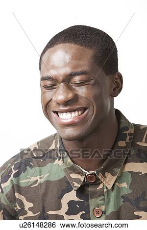 Stock Photograph - Happy young military soldier in camouflage clothing over white background. Fotosearch