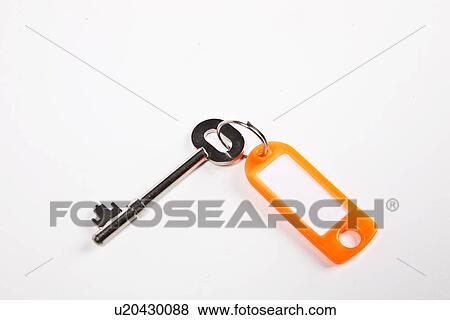 Stock Photo - Key with orange key ring tag on white background. Fotosearch