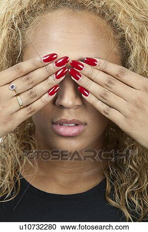 Mixed race young woman covering eyes View Large Photo Image Stock Image - Mixed race young woman covering eyes. Fotosearch