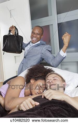 Multi-ethnic couple in bed with excited businessmen in background View Large Photo Image Stock Image - Multi-ethnic couple in bed with excited businessmen in background. Fotosearch