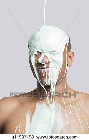Paint falling on shirtless young Hispanic man's head against gray background View Large Photo Image Stock Photo - Paint falling on shirtless young Hispanic man's head against gray background. Fotosearch