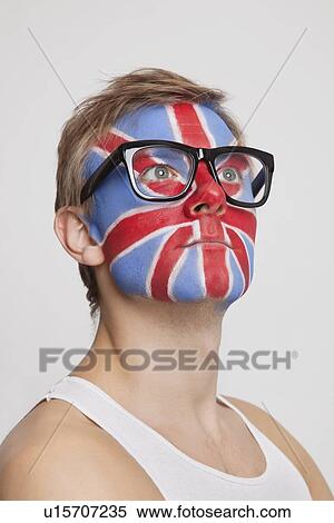 Pensive young Caucasian man with British flag painted on face wearing eyeglasses against white background View Large Photo Image Stock Photography - Pensive young Caucasian man with British flag painted on face wearing eyeglasses against white background. Fotosearch