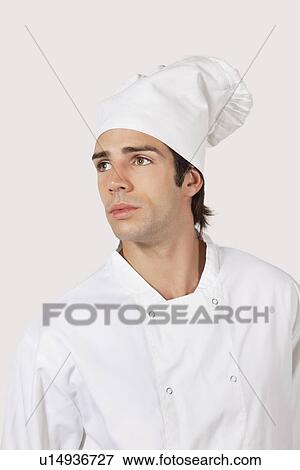 Pensive young man in chef's uniform looking away against gray background View Large Photo Image Stock Photo - Pensive young man in chef's uniform looking away against gray background. Fotosearch