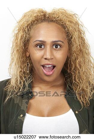 Portrait of amazed young mixed race woman with mouth open against white background View Large Photo Image Stock Photo - Portrait of amazed young mixed race woman with mouth open against white background. Fotosearch