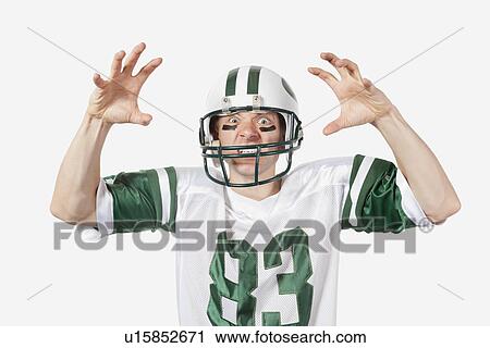 Portrait of angry young man in football uniform gesturing over gray background View Large Photo Image Stock Image - Portrait of angry young man in football uniform gesturing over gray background. Fotosearch