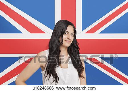 Portrait of beautiful Asian woman smiling against British flag View Large Photo Image Stock Photograph - Portrait of beautiful Asian woman smiling against British flag. Fotosearch