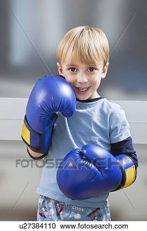 Portrait of Caucasian boy in casuals wearing boxing gloves View Large Photo Image Stock Image - Portrait of Caucasian boy in casuals wearing boxing gloves. Fotosearch