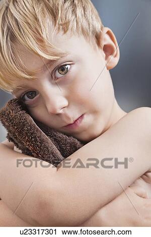Portrait of Caucasian boy wiping his face with towel View Large Photo Image Stock Image - Portrait of Caucasian boy wiping his face with towel. Fotosearch