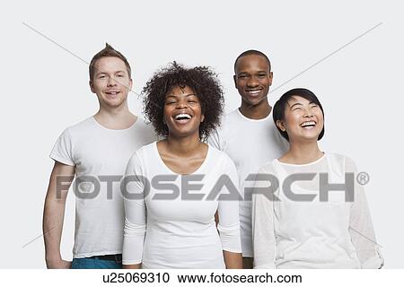 Portrait of cheerful young multi-ethnic friends in casuals over white background View Large Photo Image Stock Image - Portrait of cheerful young multi-ethnic friends in casuals over white background. Fotosearch