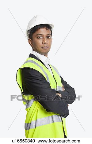 Portrait of confident Asian architect wearing reflective vest against white background View Large Photo Image Stock Image - Portrait of confident Asian architect wearing reflective vest against white background. Fotosearch