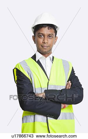 Portrait of confident Asian architect wearing reflective vest against white background View Large Photo Image Stock Image - Portrait of confident Asian architect wearing reflective vest against white background. Fotosearch