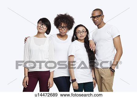Portrait of confident multi-ethnic friends in casuals standing together over white background View Large Photo Image Stock Photo - Portrait of confident multi-ethnic friends in casuals standing together over white background. Fotosearch