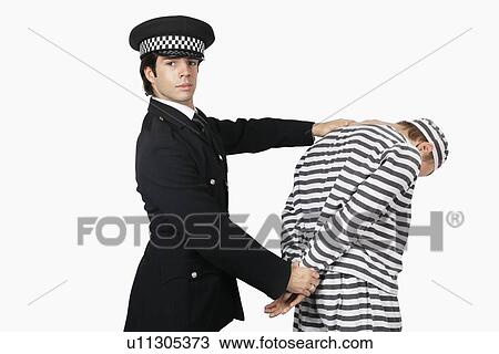Portrait of confident police officer with male prisoner against white background View Large Photo Image Stock Image - Portrait of confident police officer with male prisoner against white background. Fotosearch