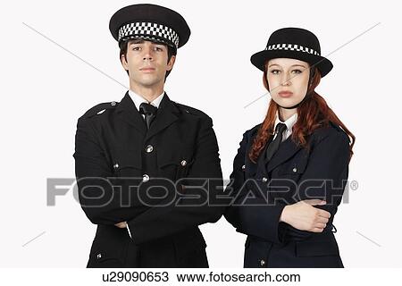 Stock Image - Portrait of confident police officers with arms crossed against white background. Fotosearch