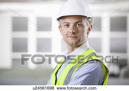 Portrait of confident young Caucasian architect smiling View Large Photo Image Stock Photo - Portrait of confident young Caucasian architect smiling. Fotosearch