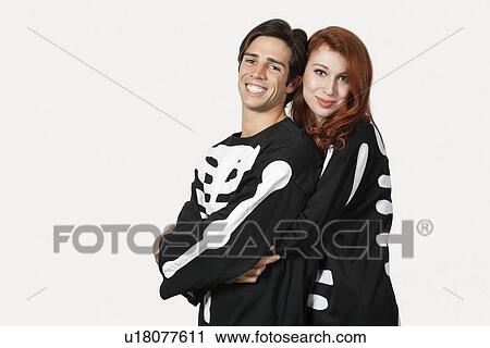 Portrait of couple in skeleton costume over gray background View Large Photo Image Stock Image - Portrait of couple in skeleton costume over gray background. Fotosearch
