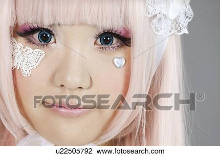 Portrait of cute woman dressed as a doll over gray background View Large Photo Image Stock Image - Portrait of cute woman dressed as a doll over gray background. Fotosearch