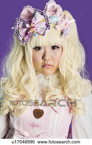 Portrait of cute woman in doll costume over purple background View Large Photo Image Stock Image - Portrait of cute woman in doll costume over purple background. Fotosearch