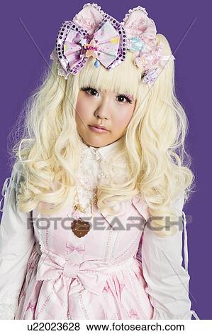Portrait of cute woman in doll costume over colored background View Large Photo Image Stock Photo - Portrait of cute woman in doll costume over colored background. Fotosearch