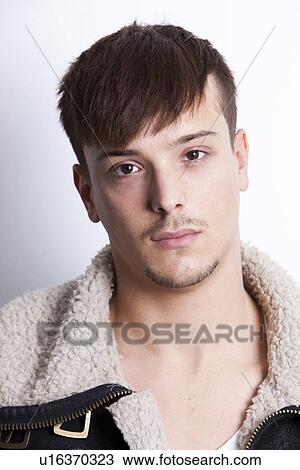 Stock Image - Portrait of handsome young man against white background. Fotosearch