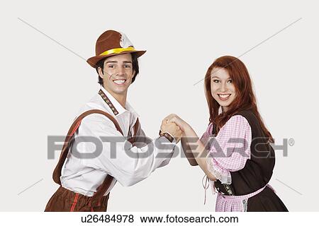 Portrait of happy couple dancing against gray background View Large Photo Image Stock Photo - Portrait of happy couple dancing against gray background. Fotosearch