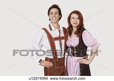 Portrait of happy couple in costume standing against gray background View Large Photo Image Picture - Portrait of happy couple in costume standing against gray background. Fotosearch