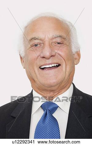 Portrait of happy elderly businessman against white background View Large Photo Image Stock Image - Portrait of happy elderly businessman against white background. Fotosearch