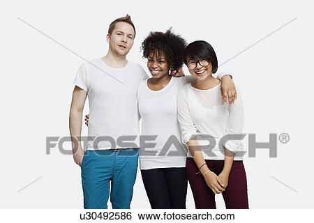 Portrait of happy multi-ethnic friends in casuals with arm around each other over white background View Large Photo Image Stock Photograph - Portrait of happy multi-ethnic friends in casuals with arm around each other over white background. Fotosearch