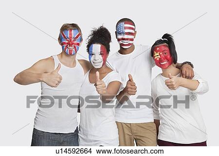 Portrait of happy Multi-ethnic group of friends with various national flags painted on their faces gesturing thumbs up against white background View Large Photo Image Picture - Portrait of happy Multi-ethnic group of friends with various national flags painted on their faces gesturing thumbs up against white background. Fotosearch