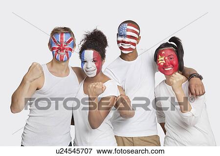 Stock Photo - Portrait of happy Multi-ethnic group of friends with various national flags painted on their faces celebrating success against white background. Fotosearch
