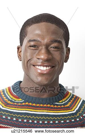 Portrait of happy young African American man in knitwear against white background View Large Photo Image Stock Photograph - Portrait of happy young African American man in knitwear against white background. Fotosearch