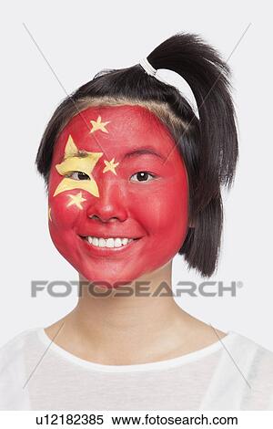 Portrait of happy young Asian woman with Chinese flag painted on face against white background View Large Photo Image Stock Photography - Portrait of happy young Asian woman with Chinese flag painted on face against white background. Fotosearch
