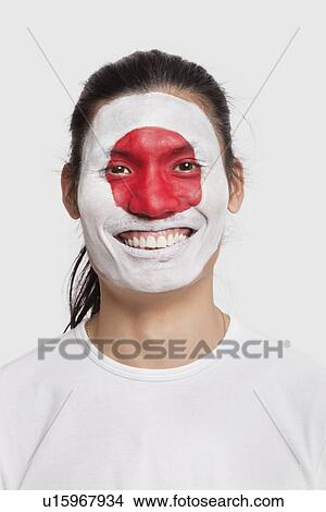 Portrait of happy young mixed race man with Japanese flag painted on face against white background View Large Photo Image Picture - Portrait of happy young mixed race man with Japanese flag painted on face against white background. Fotosearch