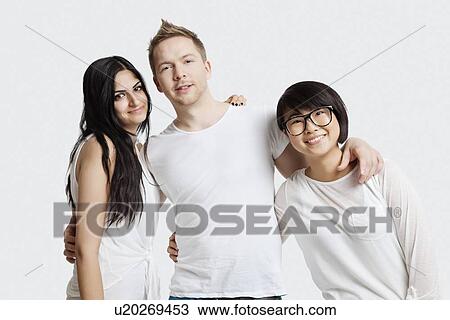 Portrait of multi-ethnic friends in casuals smiling over white background View Large Photo Image Stock Image - Portrait of multi-ethnic friends in casuals smiling over white background. Fotosearch