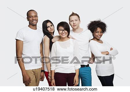 Stock Photo - Portrait of multi-ethnic friends in casuals smiling together over white background. Fotosearch