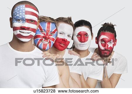 Stock Photo - Portrait of Multi-ethnic group of male friends with various national flags painted on their faces standing against white background. Fotosearch