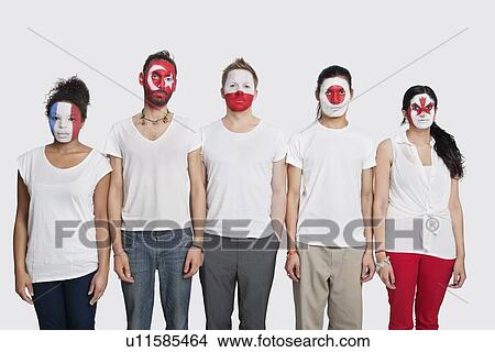 Portrait of Multi-ethnic group of friends with various national flags painted on their faces standing at attention against white background View Large Photo Image Picture - Portrait of Multi-ethnic group of friends with various national flags painted on their faces standing at attention against white background. Fotosearch