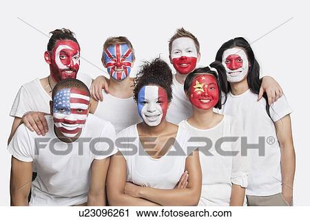 Stock Image - Portrait of Multi-ethnic group of friends with various national flags painted on their faces against white background. Fotosearch