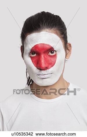 Portrait of serious young mixed race man with Japanese flag painted on face against white background View Large Photo Image Stock Image - Portrait of serious young mixed race man with Japanese flag painted on face against white background. Fotosearch