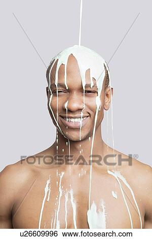 Portrait of shirtless young man with paint falling on his head against gray background View Large Photo Image Stock Photograph - Portrait of shirtless young man with paint falling on his head against gray background. Fotosearch