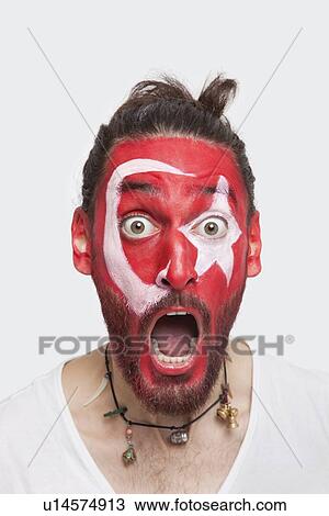 Portrait of shocked young man with Turkish flag painted on face screaming against white background View Large Photo Image Stock Image - Portrait of shocked young man with Turkish flag painted on face screaming against white background. Fotosearch