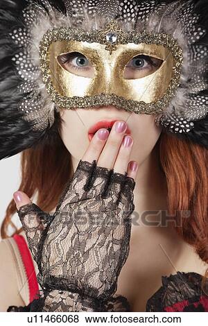 Portrait of shocked young woman with feathered eye mask View Large Photo Image Stock Photo - Portrait of shocked young woman with feathered eye mask. Fotosearch