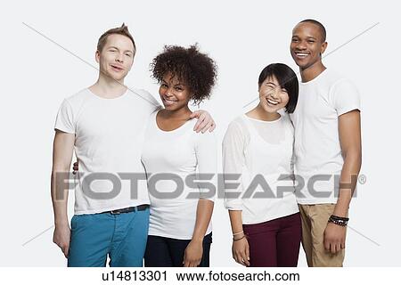 Portrait of two cheerful young couples in casuals standing together over white background View Large Photo Image Stock Image - Portrait of two cheerful young couples in casuals standing together over white background. Fotosearch