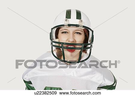Portrait of woman in football uniform against gray background View Large Photo Image Stock Photo - Portrait of woman in football uniform against gray background. Fotosearch