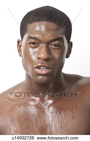 Portrait of young African American man sweating over white background View Large Photo Image Stock Photograph - Portrait of young African American man sweating over white background. Fotosearch