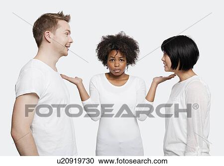 Portrait of young African American woman being ignored by friends over white background View Large Photo Image Stock Image - Portrait of young African American woman being ignored by friends over white background. Fotosearch