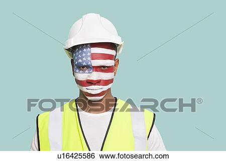 Portrait of young architect with American flag painted on face against colored background View Large Photo Image Stock Photograph - Portrait of young architect with American flag painted on face against colored background. Fotosearch