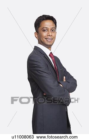 Portrait of young Asian businessman in suit with arms crossed against white background View Large Photo Image Stock Image - Portrait of young Asian businessman in suit with arms crossed against white background. Fotosearch